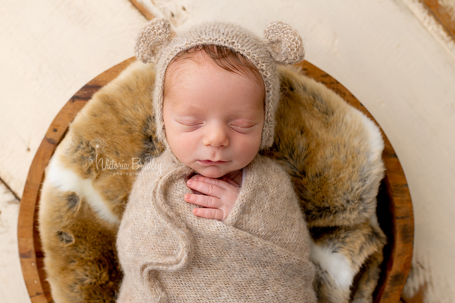 wrapped baby in bear hat