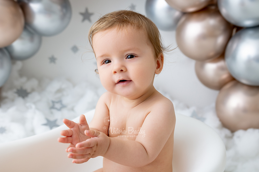 clapping sitter baby boy in bath