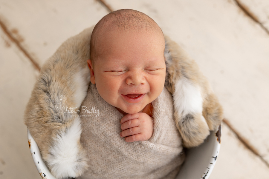 smiley wrapped newborn