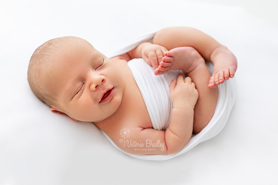 smiling newborn on white