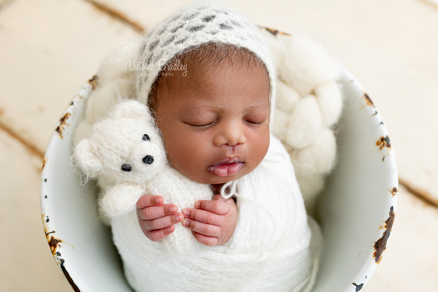 wrapped newborn with tiny bear