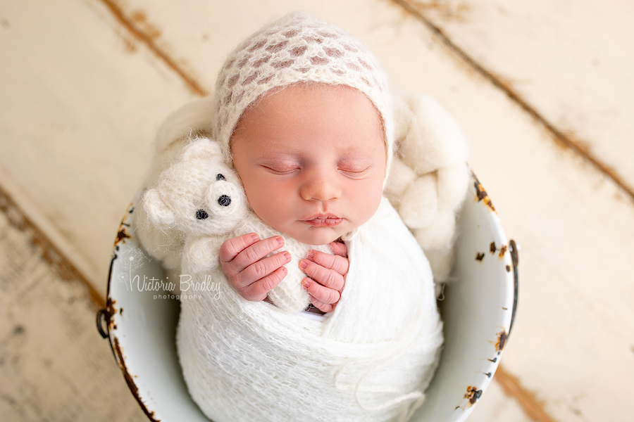 wrapped newborn baby in white photography