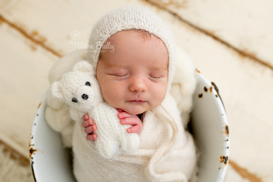 wrapped newborn with white teddy