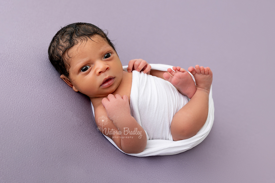 newborn baby on lilac