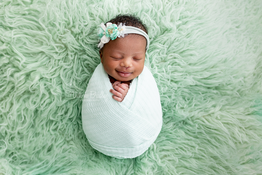 smiling baby in mint flokati 