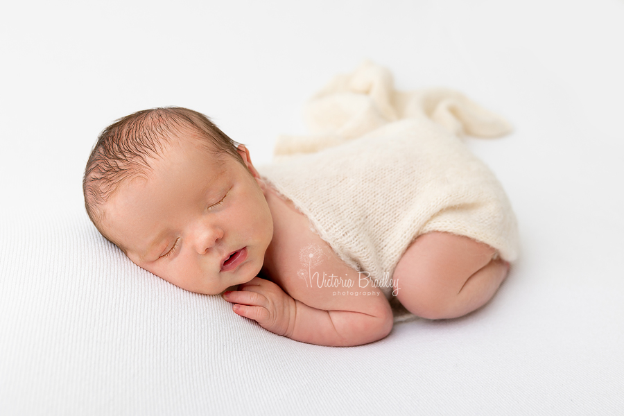 sleepy newborn on tummy