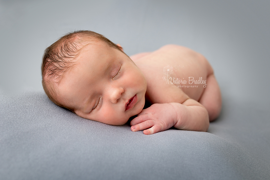 newborn on grey backdrop