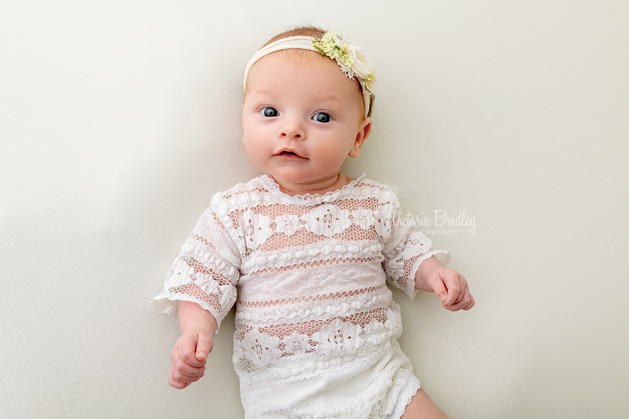 awake newborn on lemon backdrop