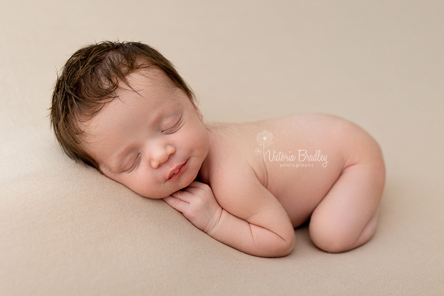 sleepy newborn on tummy