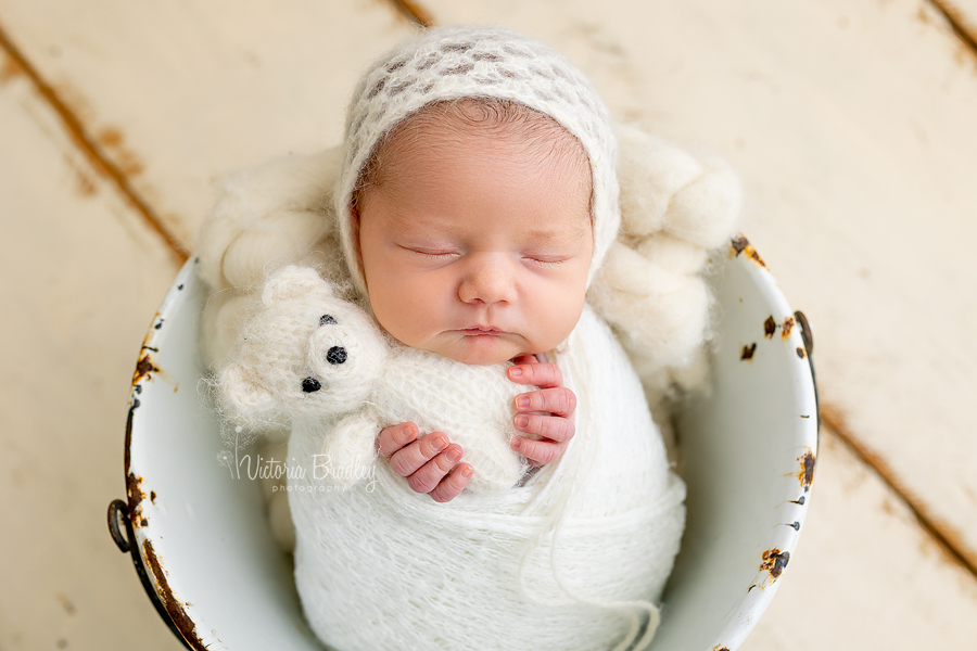 wrapped newborn with white teddy