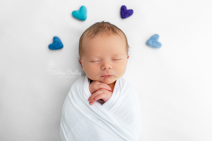 wrapped newborn on white