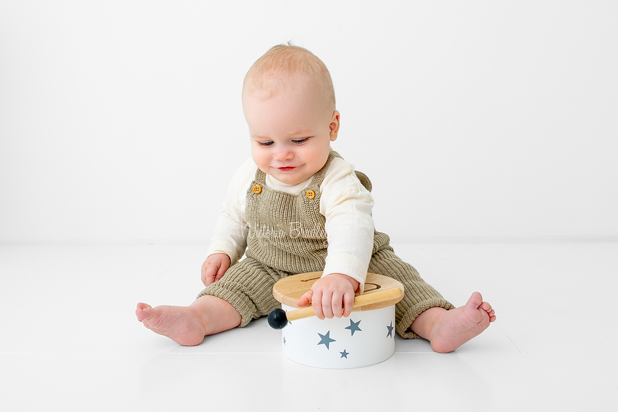 baby playing with a drum