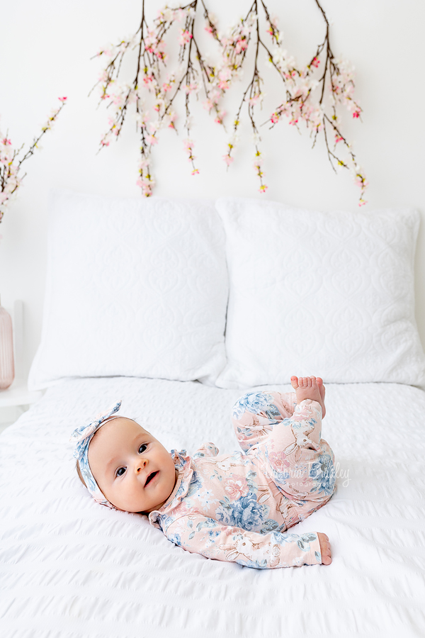 smiley newborn girl with cherry blossoms