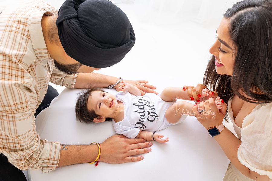 smiling baby girl with family