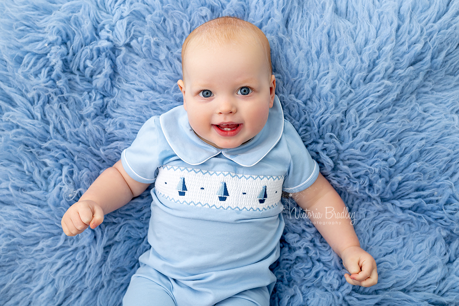 1 year old baby boy on blue rug