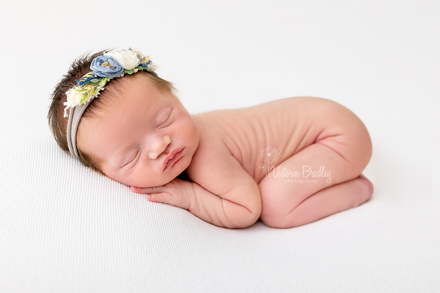 sleepy newborn on tummy