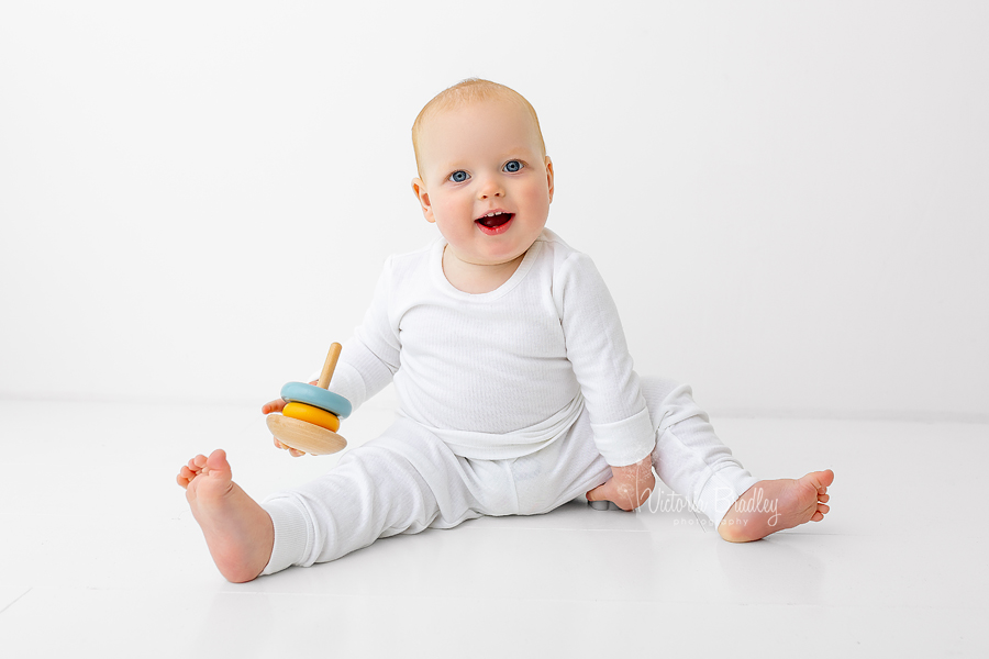 white studio 1 year old boy in white pjs