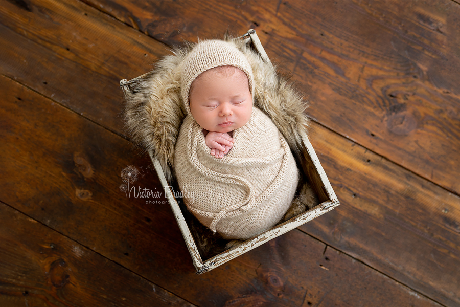 wrapped newborn in crate