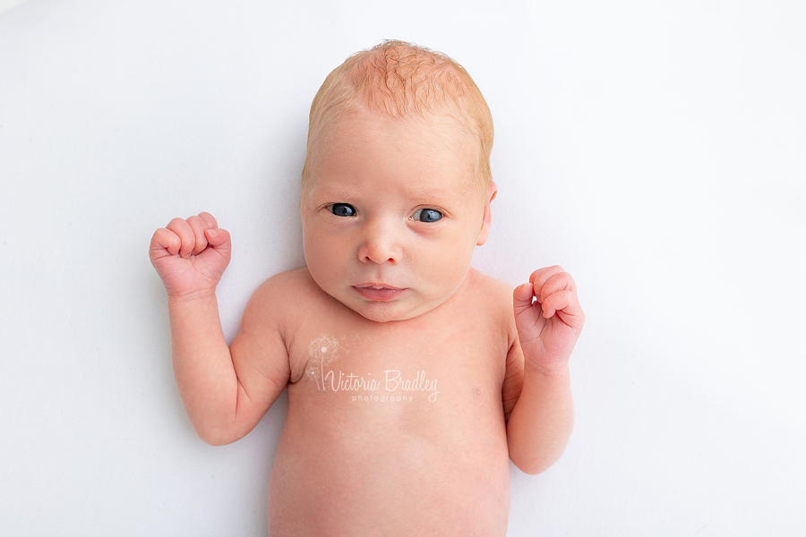 awake newborn on white