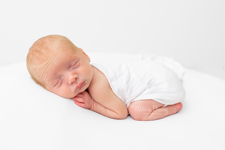 sleepy newborn on tummy