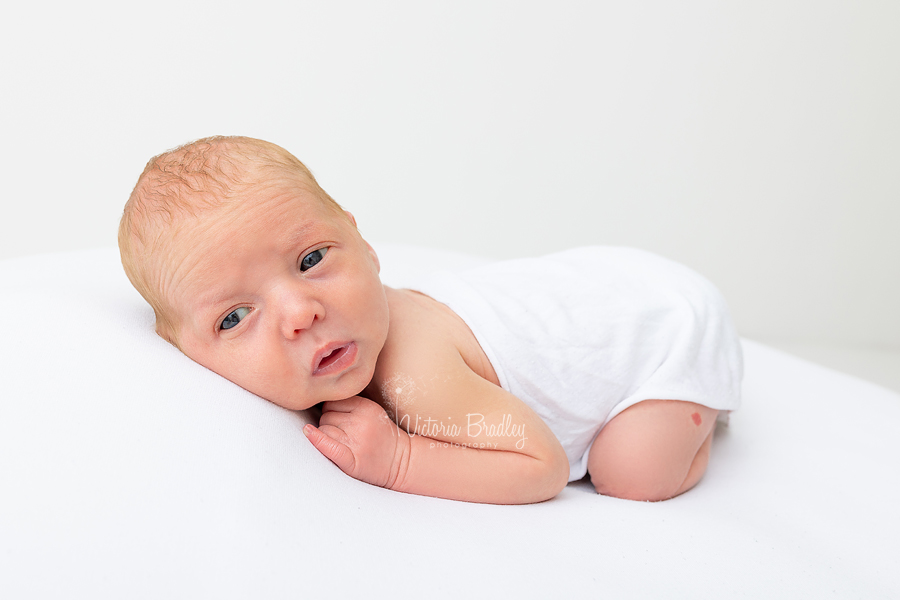 awake newborn on tummy