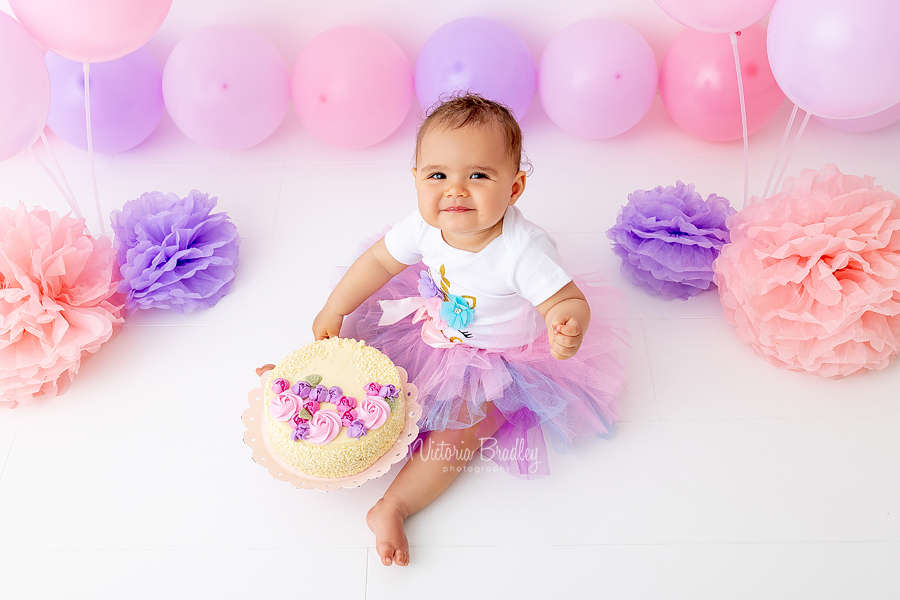 cake smash photography pink and purple with cake