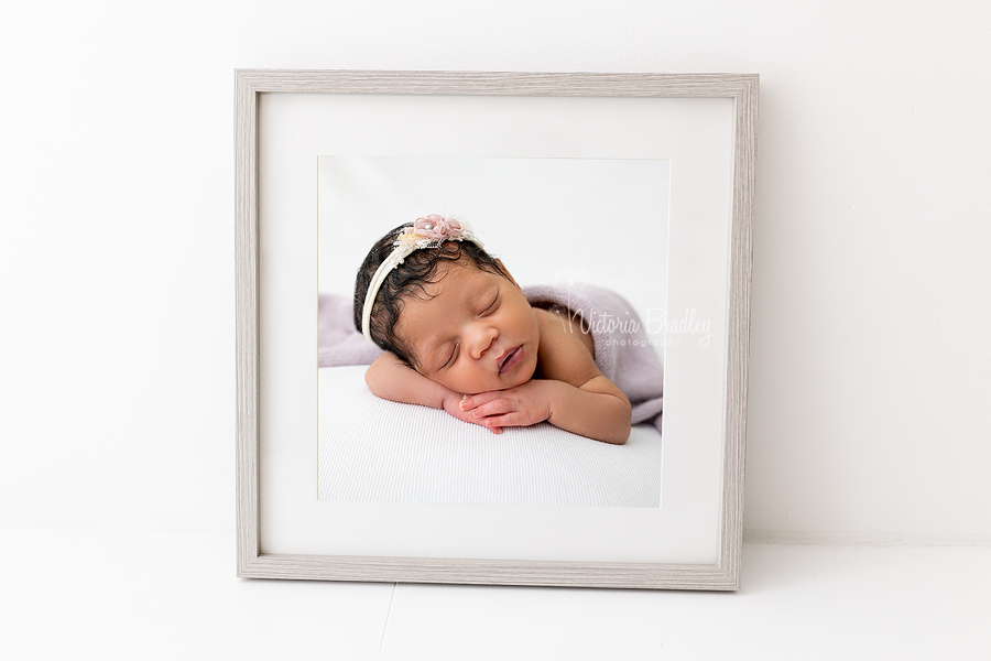 framed image of newborn baby