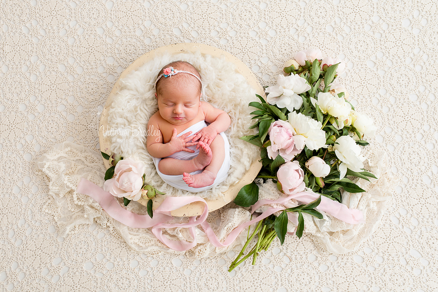 newborn in flower basket