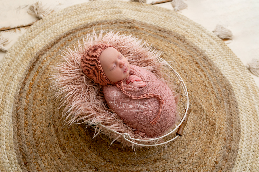 wrapped newborn in dusky pink wrap