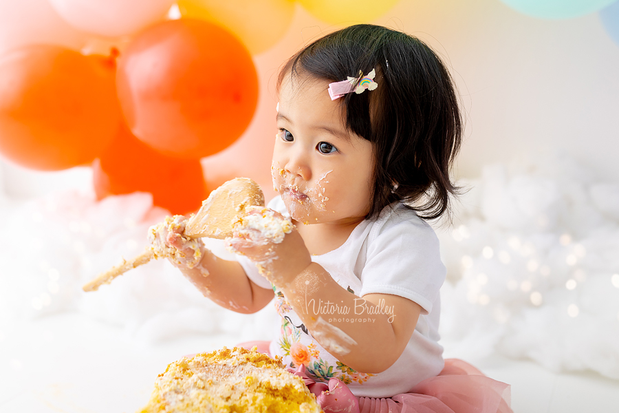 baby cake smash with wooden spoon rainbow colours