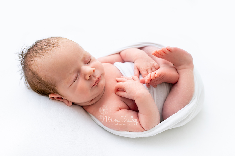 wrapped newborn on white