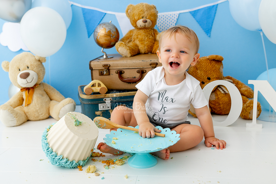 smiling baby boy blue cake bash