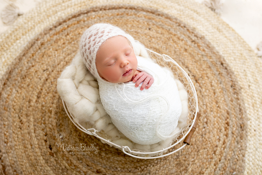 wrapped newborn in white knitted wrap