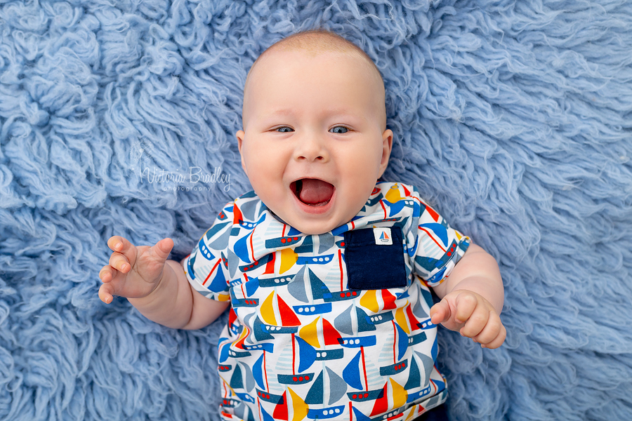 smiley baby photography on blue flokati