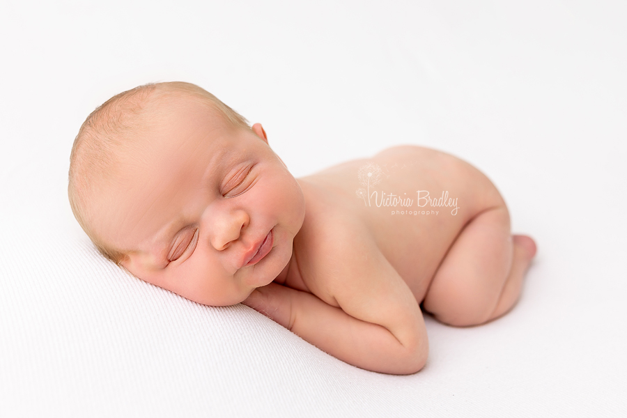 sleepy newborn on tummy