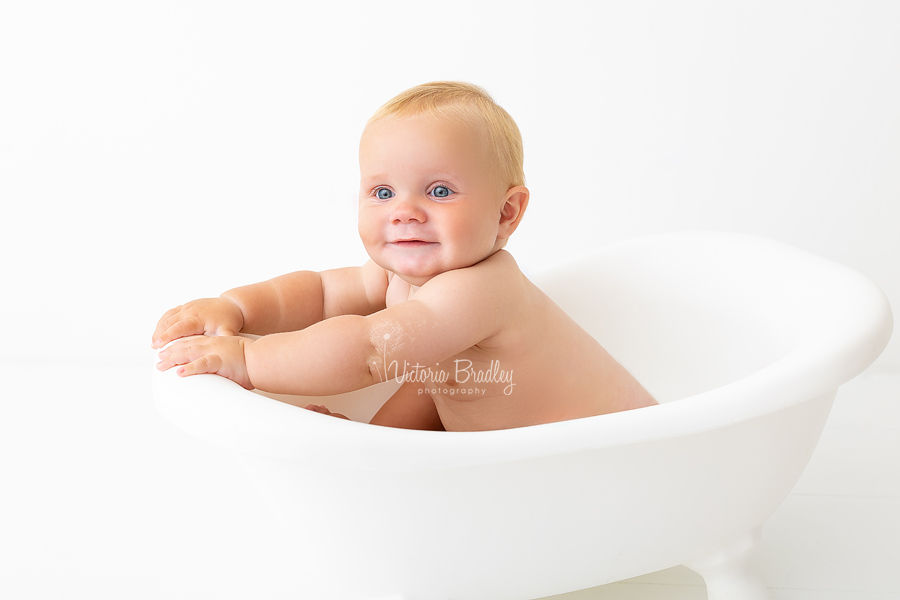 baby boy in white bath tub cake smash session