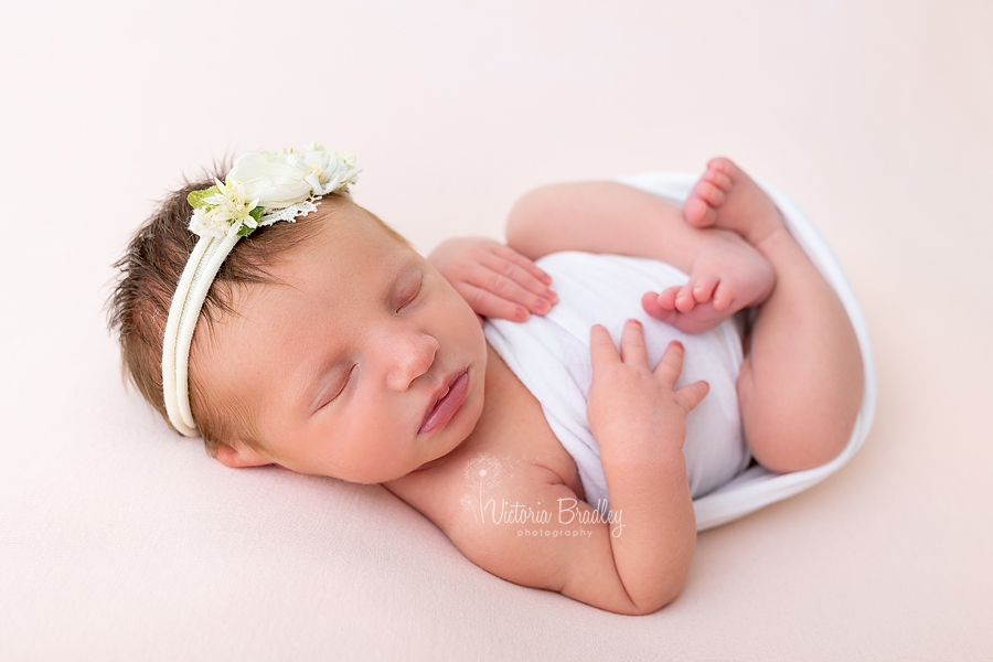 sleepy newborn on back