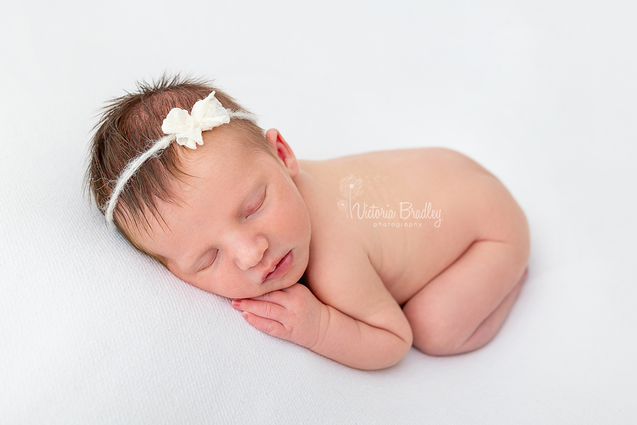 sleepy newborn on tummy