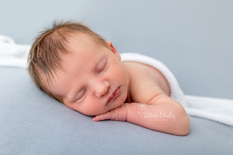 newborn baby girl on grey