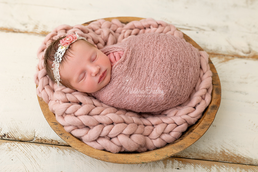 sleepy newborn on dusky pink