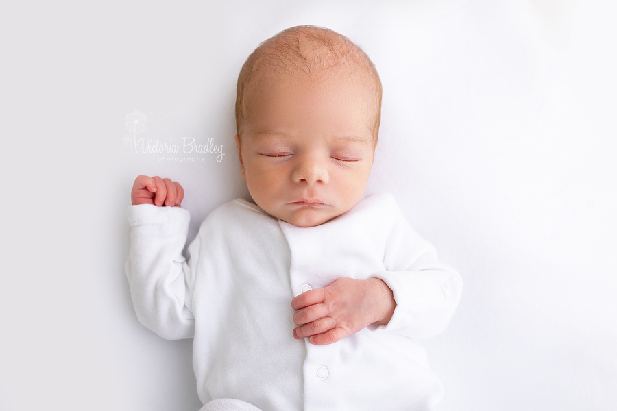 sleepy newborn on white