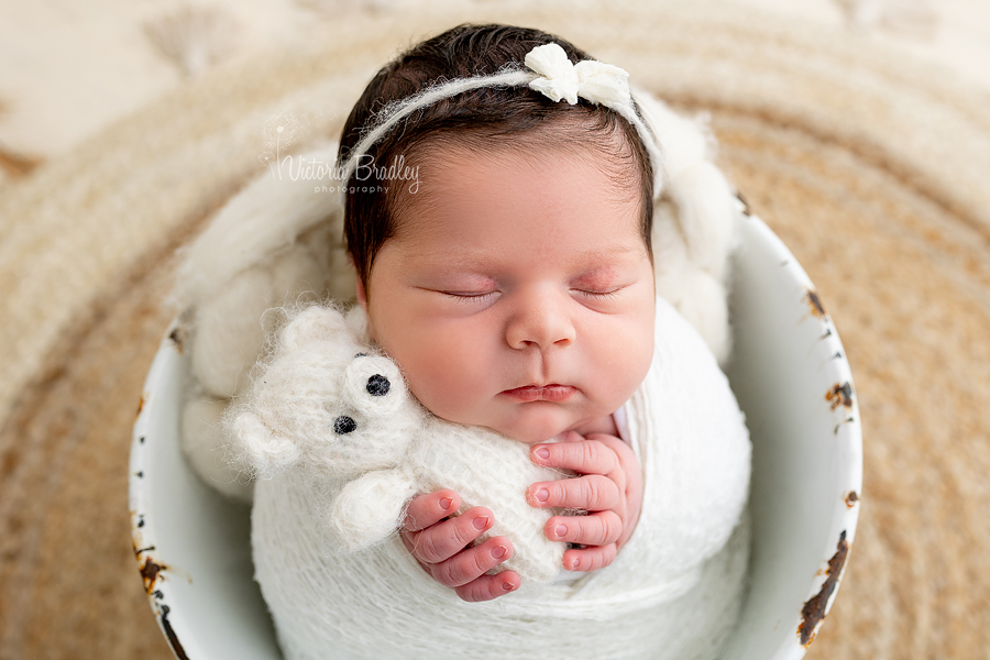 asleep newborn in bucket