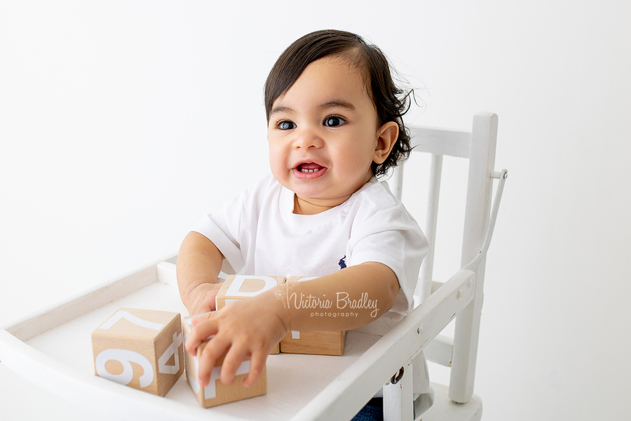 baby boy in high chair with blocks
