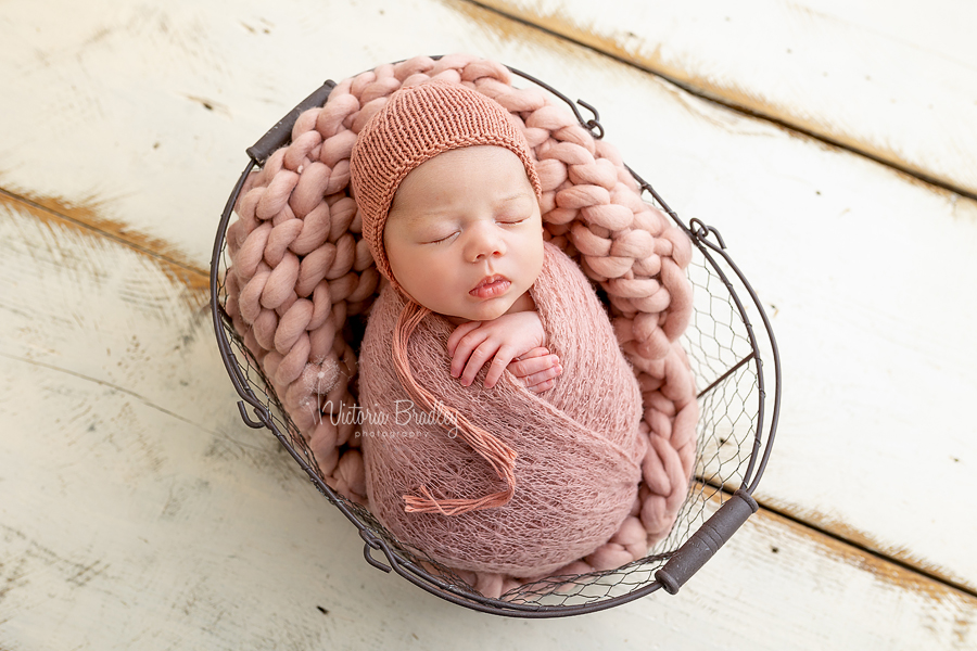 wrapped newborn in rose pink