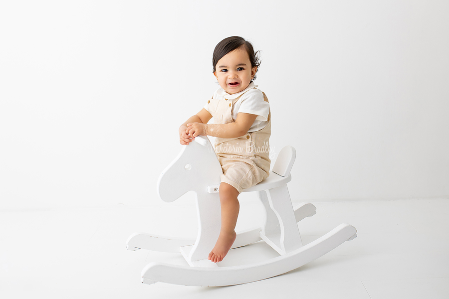 baby boy on rocking horse photography 