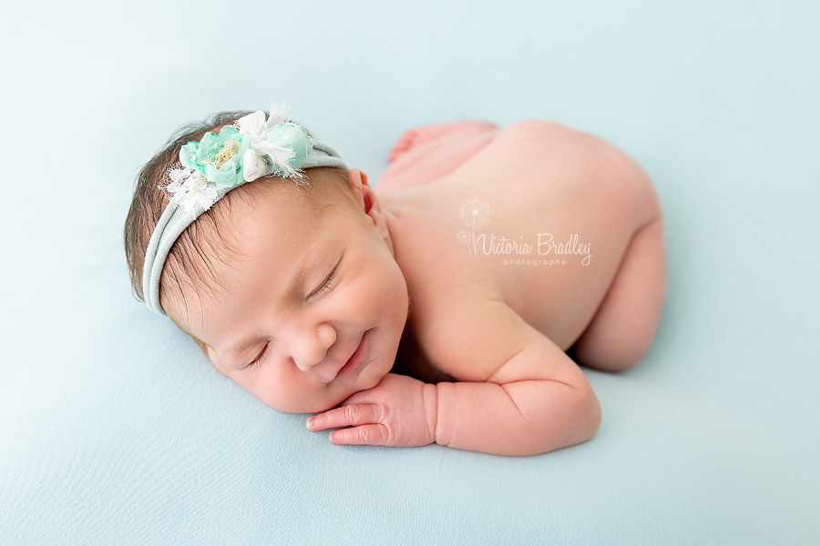 sleepy baby newborn girl on blue