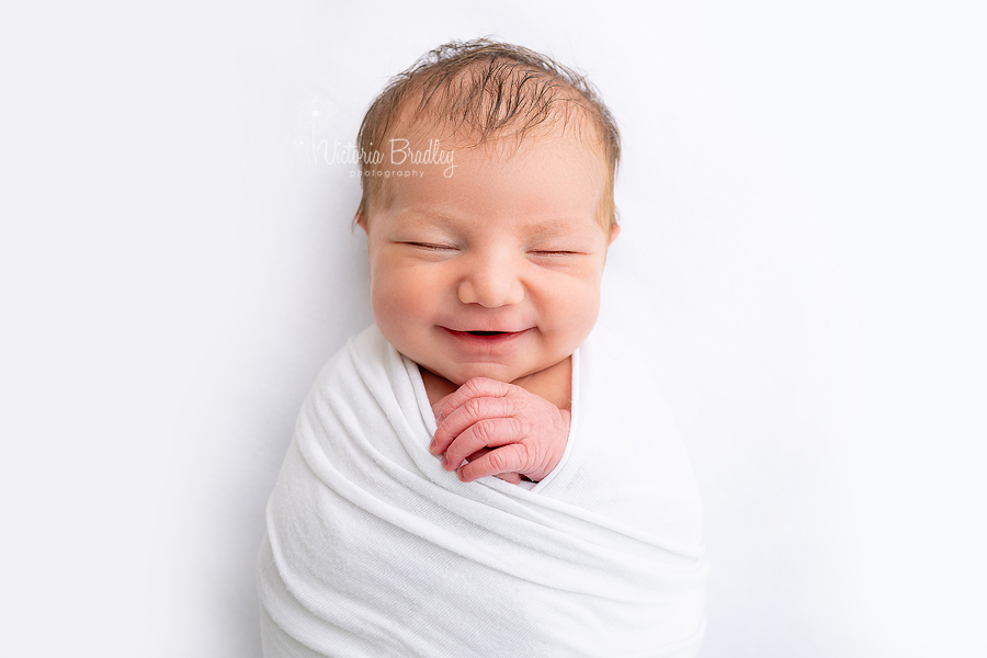 smiling 7 day old, baby A