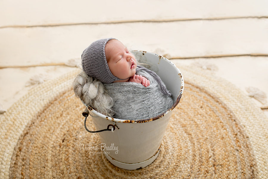 newborn wrapped in bucket photography 