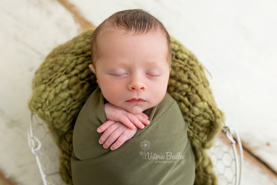 wrapped newborn in olive green